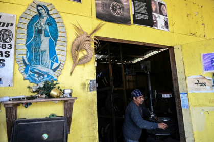 Erik Payan, originally from Mexico, works in his tire repair shop in Cleveland, Texas, on March 25, 2025 as he did on a day in February shortly before masked and armed immigration agents came to detain him