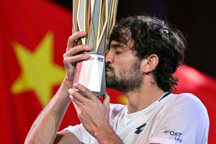 Monaco's Valentin Vacherot poses with the trophy after his victory against France’s Arthur Rinderknech - HECTOR RETAMAL (AFP)