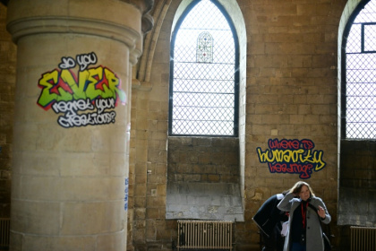 Graffiti-style artworks at Canterbury Cathedral pose ordinary people's questions to God - Ben STANSALL (AFP)