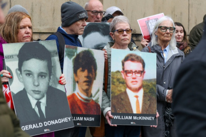 Relatives gathered outside the Belfast court at the start of the trial last month bearing posters of those killed on Bloody Sunday - Paul Faith (AFP)