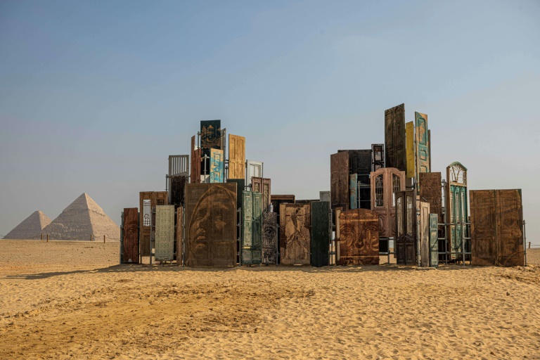 Monumental art displayed in shade of Egypt's pyramids