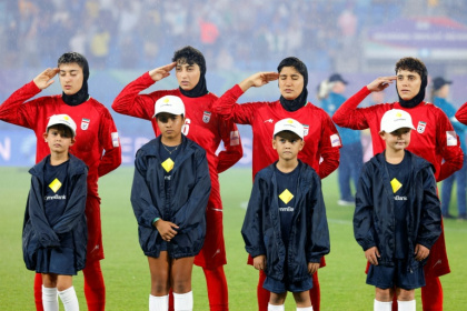 Iran's players salute during the national anthem before the AFC Women's Asian Cup Australia 2026 football match between Iran and Philippines in Gold Coast on March 8, 2026 - STR (AFP)